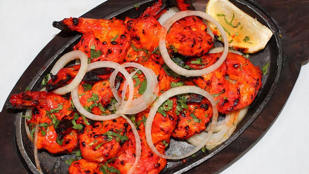 Shrimp Tandoori · Shrimp marinated in homemade curd with herbs and mild spices then cooked in clay oven.  Served with naan or rice.