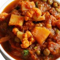 Aloo Matar Gobi · Aloo matar gobi potatoes, peas, and cauliflower cooked in mild spiced gravy. Served with ric...