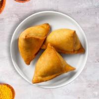 Chicken Samosa · Chicken in a fried crispy wheat layer. Served with tamarind chutney and mint. 4 pieces.