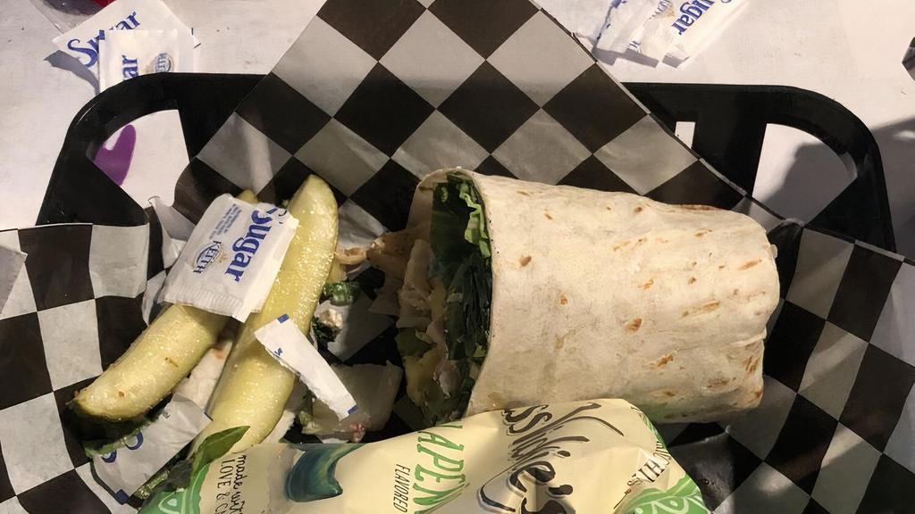 The Italian Wrap · New. Served with a side of your choice and our classic pickle spear. Tortilla stuffed with ham, salami, pastrami, provolone, artichoke hearts, tomatoes, black olives, shredded lettuce and tossed in our Italian dressing.