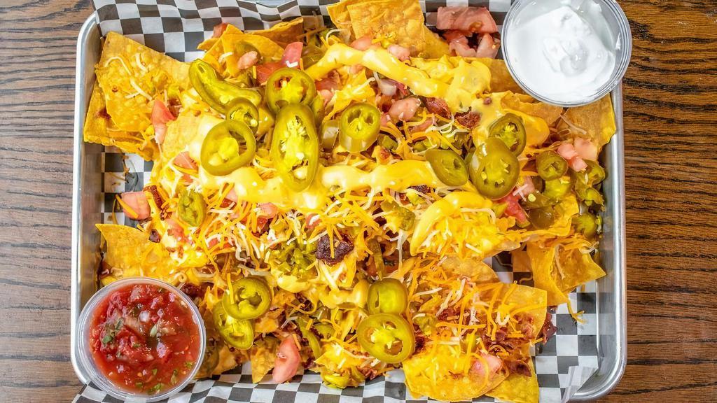 Tavern Nachos · House-made tortilla chips piled high with two cheeses, tomato, jalapenos, and fire roasted corn salsa.  Red tomato salsa and sour cream served on the side.