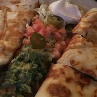 Quesadilla · Flour tortilla filled with melted cheese - served with lettuce, tomato, jalapeño, sour cream...