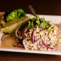 Lahb · Choice of cooked ground meat and onions tossed in a fresh lime juice dressing and parched ri...