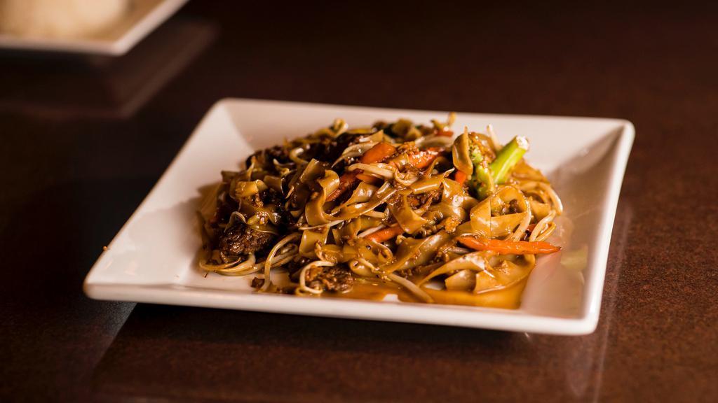 Pad See-Lew · Stir-fried rice noodles with your choice of meat, eggs and Chinese broccoli in sweet black soy sauce.