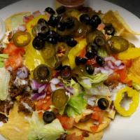 Nachos Supreme · Tortilla chips topped with white queso cheese, beef or chicken, onions, black olives, tomato...