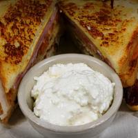 Carey Club · Turkey, ham, bacon, swiss and American, lettuce, tomato, and mayo on sourdough bread.