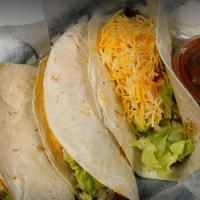Tacos · Three beef tacos, soft or hard shell, served with salsa and sour cream.