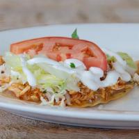 Tostada Pollo (Spicy) · Spicy Chicken Tostada. Topped with beans, cheese, lettuce, tomato, cilantro, onion, and sour...