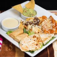 Mambo Sampler · A sample of nachos, chicken quesadilla, tamale, beef enchilada, flauta, guacamole and queso ...
