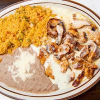 Pollo Con Queso · Grilled chicken strips topped with cheese sauce. Served with rice and beans.