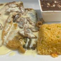 Chiles Poblanos · Two poblanos peppers stuffed with cheese topped with ranchera sauce, served with rice and be...