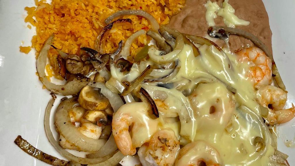 Camarones Fundidos · Grilled shrimp cook with sautéed onions and mushrooms topped with Monterrey Jack cheese, served with rice and guacamole salad.