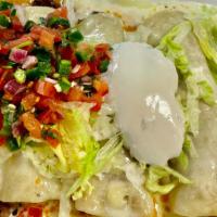 Enchiladas Supreme · Four enchiladas beef, chicken, beans and cheese with guacamole salad on top.