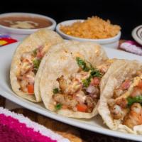 Baja Shrimp Tacos · Three flour tortillas with grilled shrimp, chipotle sauce, cabbage and pico de gallo, served...