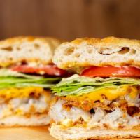 Crispy Fish Sandwich · Battered Cod Loin, American Cheese, Lettuce, Tomato, and *CHIPOTLE* Tartar Sauce on a Gourme...