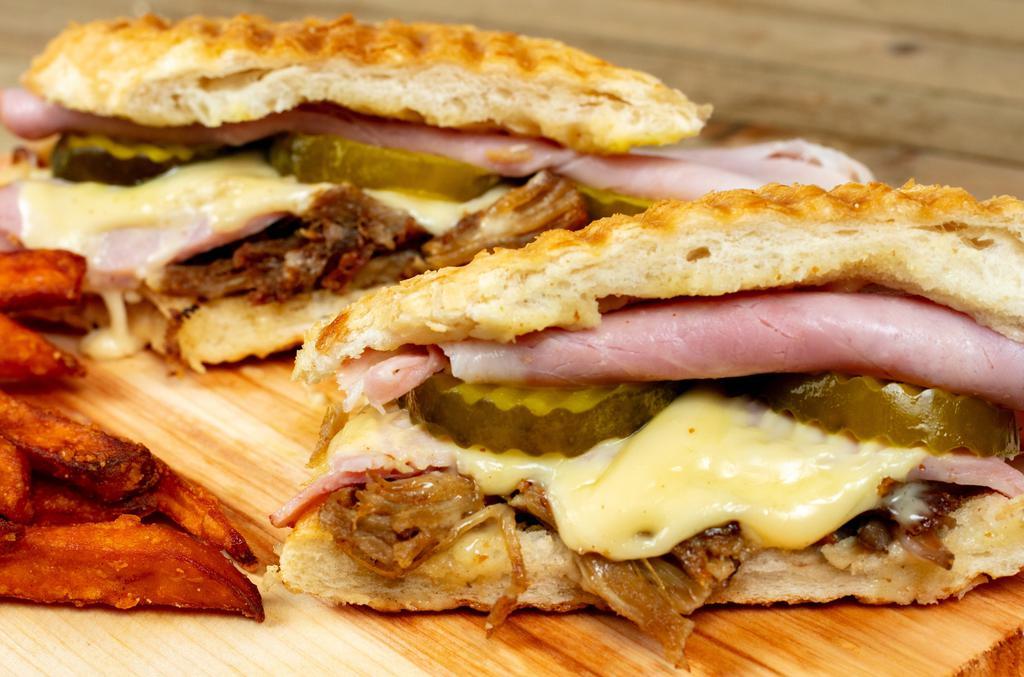 Cuban Press · Pulled Pork, Smoked Ham, Sweet Pickle, Dijon Mustard, and Swiss Cheese on a French Roll.