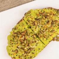 Avocado Lover' Toast · Fresh avocado topped with pepitas and red pepper flakes on sourdough bread / multigrain.