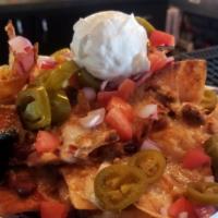 T&T Nachos · house chili with pepperjack queso, shredded cheddar, tomatoes, onions & pickled jalapenos. t...