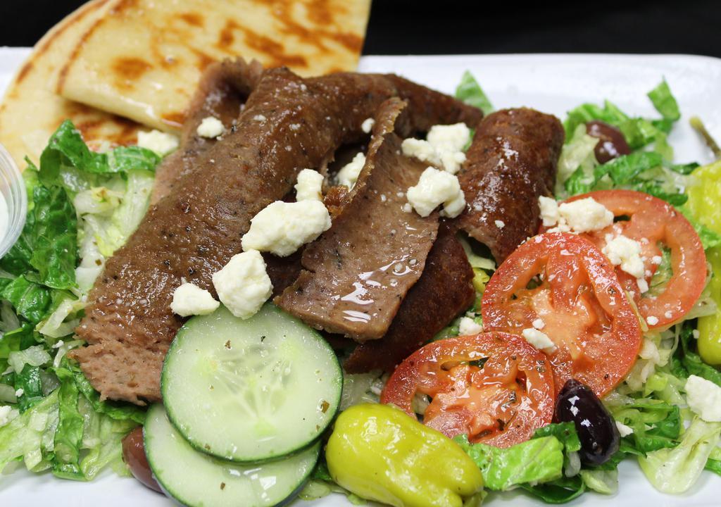 Gyro Salad · Gyro meat, romaine-iceberg lettuce, cucumber, tomato, red onion, kalamata olives, pepperoncini, feta cheese, Greek dressing, tzatziki sauce, pita.