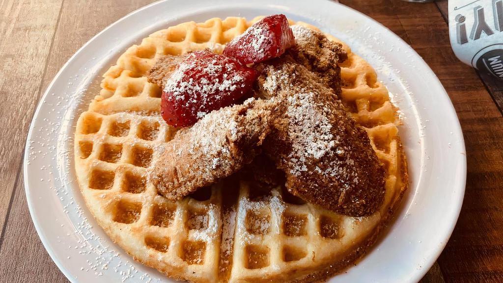 Chicken & Waffles · Seasoned Chicken Wings atop a fluffy Belgian Waffle sprinkled with strawberries and powdered sugar. Accompanied by our custom buttered maple syrup.