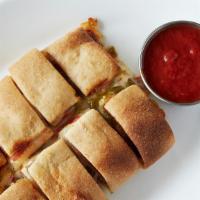 Meat Stromboli · Rolled pizza dough stuffed with ham, picante salami, green and red peppers, and mozzarella, ...