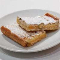Lemon Pistachio Bar · 1 bar |  a pastry crust base, topped with lemon pistachio curd, then dusted with powdered su...