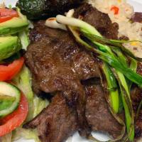 Carne Asada · Grilled steak. Served with rice, salad, refried beans, and corn tortillas.