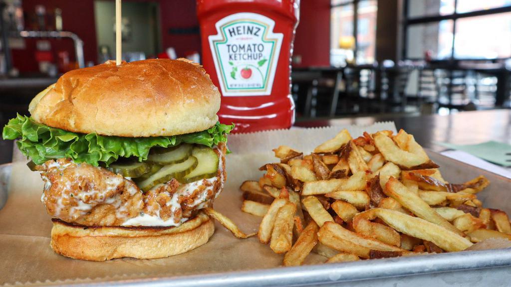 Smothered Ranch Chicken Sandwich · Hand breaded chicken breast fried and smothered in house made ranch dressing then topped with lettuce, tomato. Served with fries.