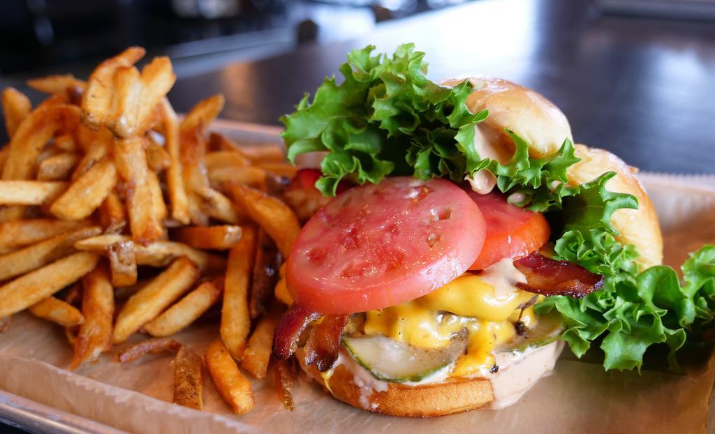 Bacon Cheeseburger · Two 3-ounce hand patted smash burgers topped with smokehouse bacon American cheese, leaf lettuce, tomato, house made bread and butter pickles and house made M&T special sauce. Served with fries.