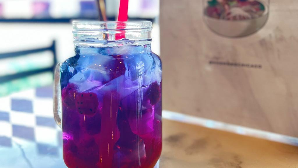 Dragon Passion Tea · A special tea that has 3 layers of color which mixes into a vibrant violet color when stirred. All color are from natural tea and fruits. It is healthy, delicious and pretty at the same time.