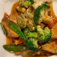 Home Style Tofu · Deep fried tofu stir-fried with broccoli, baby corn, napa, snow pea, and carrot in a brown s...