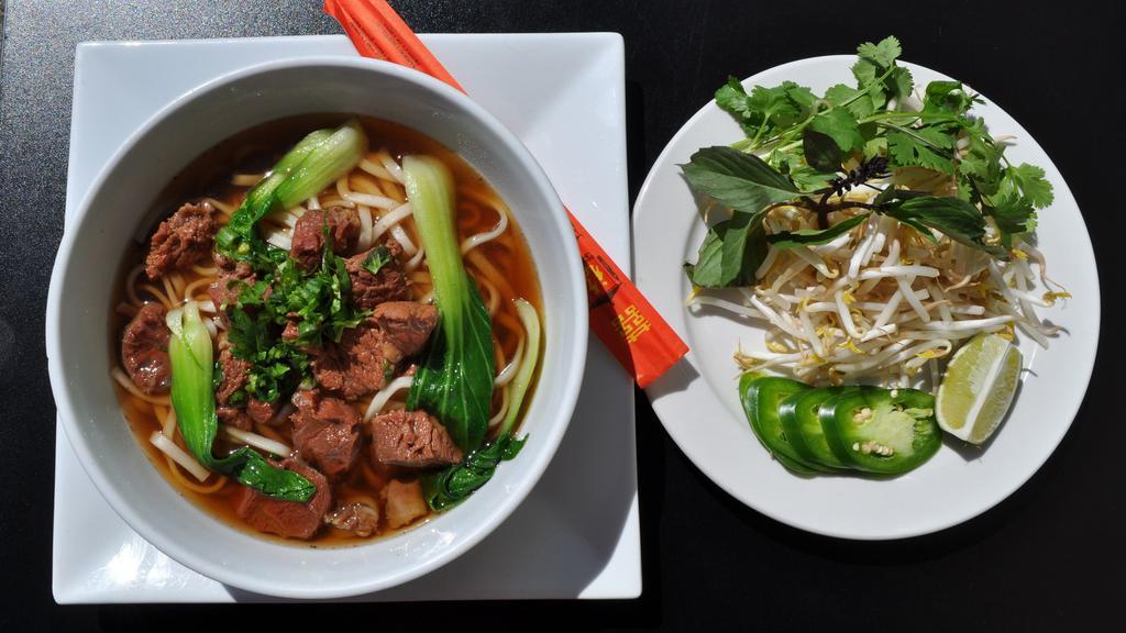 Beef Spicy Noodle Soup（牛腩面） · Spicy. Served with stewed beef, flour noodles, bok choy, and garnished with scallion