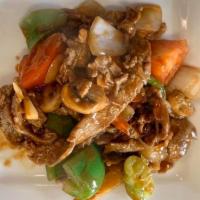 Pepper Steak · Marinated flank steak with green pepper, onion, carrot, mushroom, and tomato in a brown sauce