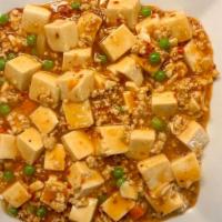 Ma Po Tofu (麻婆豆腐饭） · Spicy. Hot & Spicy. 
Soft tofu sautéed with carrot, pea, and ground chicken in a spicy sauce