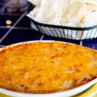 Bean Dip - Frijoles Y Mas · Layered dip with refried beans, red sauce, onions, and cheese. Served with crisp corn or flo...