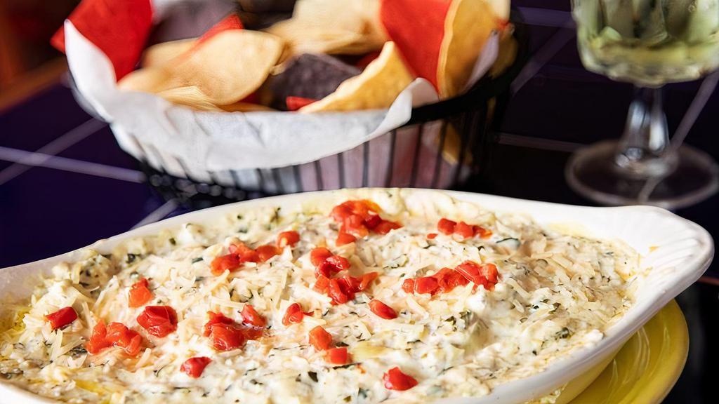 Artichoke Spinach Dip · Artichoke, spinach and Parmesan dip served with seasoned, tri-colored chips.