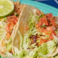 Fish Tacos · Two tacos filled with seasoned tilapia and our own special sauce on soft corn tortillas. Ser...
