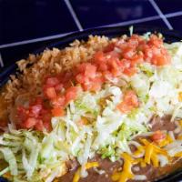 Tacolada · A rolled flour tortilla stuffed with ground beef or shredded chicken, Cheddar and Jack chees...