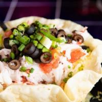 Seafood Taco Salad · Shredded lettuce, tomato, black olives, cheese, and scallions topped with shrimp and surimi ...