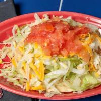 Tostada · Served on a fried corn tostada shell and topped with shredded lettuce and fresh diced tomato...
