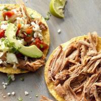 Tostadas · Two crispy tortillas spread with refried beans and topped with lettuce, queso fresco, sour c...