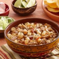 Pozole · White hominy simmered in pork broth,. Topped  with onions, radishes, cilantro, lettuce, and ...