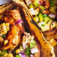 Seafood Tacos · Three soft flour tortillas filled with shrimp or tilapia and topped with lettuce, corn salsa...