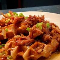 Chicken And Waffles · Smoked pulled chicken in spicy maple syrup over Belgian sugar pearl waffles garnished with g...