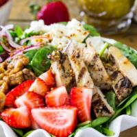 Strawberry Pecan Grilled Chicken Salad · Field greens, crisp romaine, fresh strawberries, red onion, smoked bacon, candied pecans, gr...