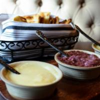 Melted Fondue Trio · Gluten-free friendly. Brie and chablis, Emmenthaler and sauvignon blanc, new York cheddar an...
