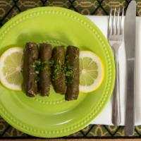 Grape Leaves · Grape leaves rolled and stuffed with rice, tomatoes, onions, and parsley. Cooked in extra vi...