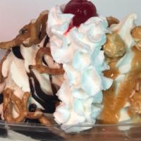 Shipwreck Special · Two towers of vanilla soft serve with hot caramel hot fudge, caramel corn and pretzels.  Whi...