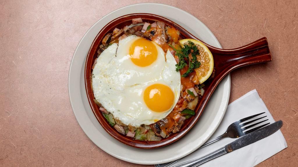 Skillet Deluxe · American fried potatoes, diced ham, onion, green pepper, mushrooms, topped with shredded cheddar cheese, and two eggs on top. Served with your choice of toast and jelly.
