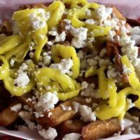Macedonian Fries · Our hand-cut fries smothered in our creamy Macedonian dressing topped with feta cheese crumb...